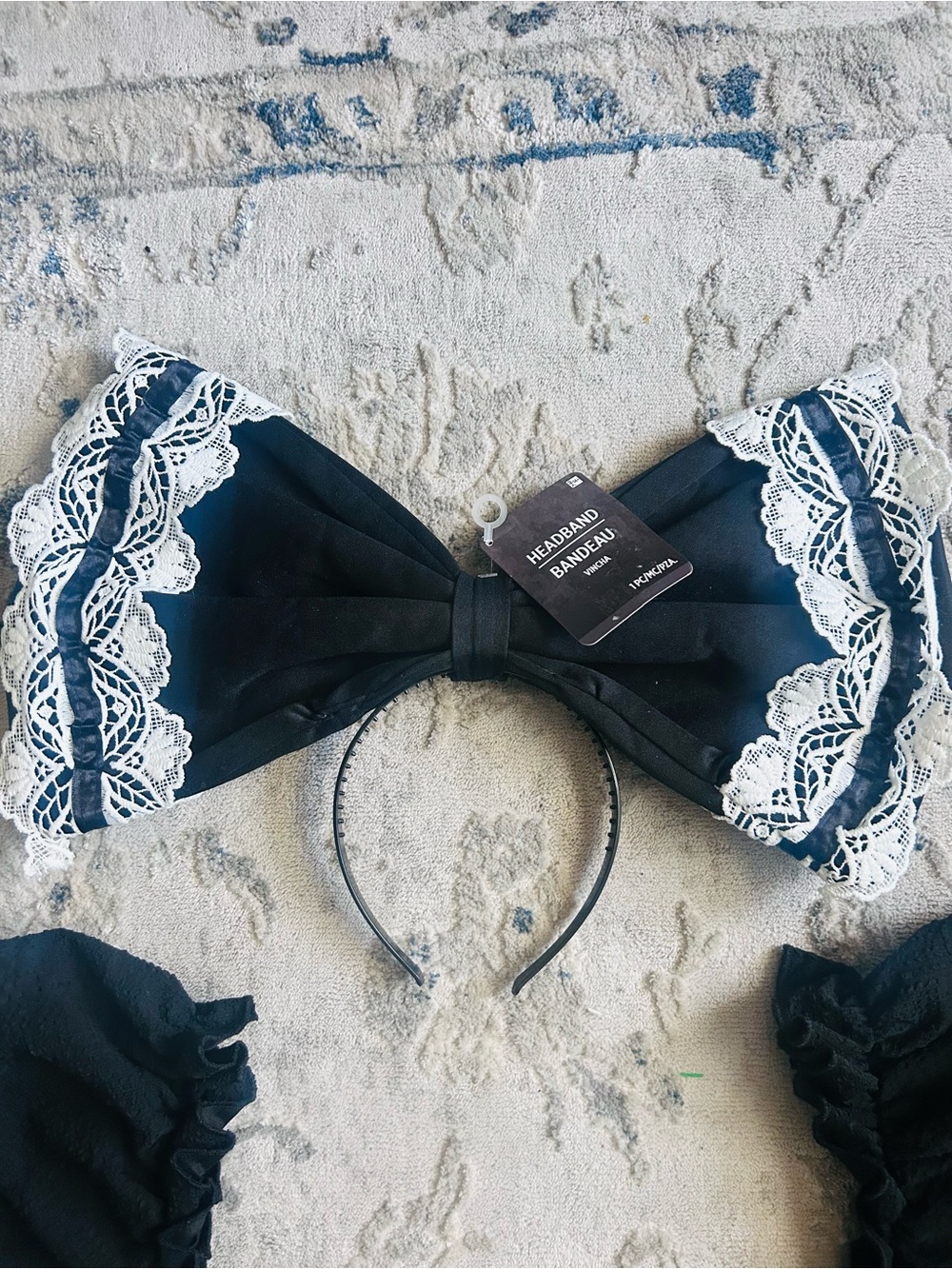 large black fabric bow headband trimmed with white lace